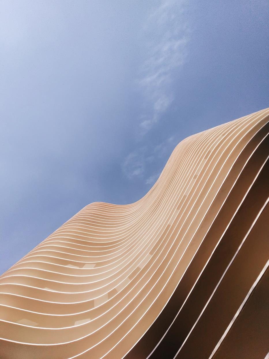 Curved architectural façade against sky