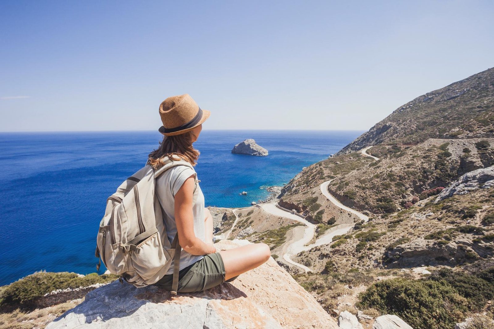Traveller looking over a Mediterranean coastline